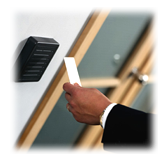 person scanning their security badge at a door.